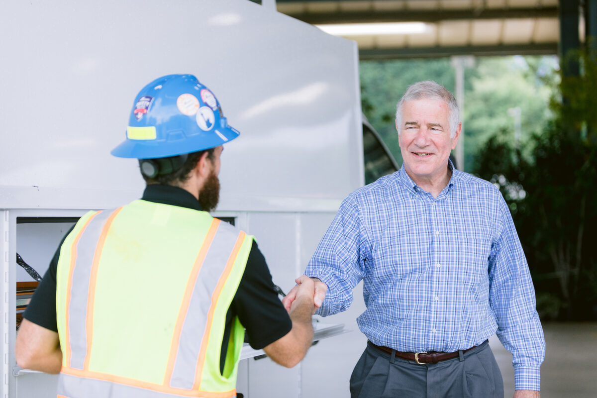 John Blust greeting a local worker